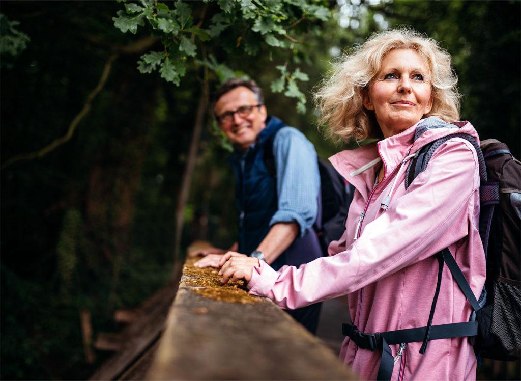 older couple hiking in woods